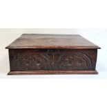 Antique carved oak bible box, the rectangular top with moulded edge, the carved front panel on