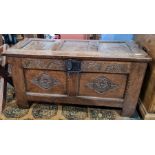 Oak coffer with carved channel decoration to the top, carved front and stile supports