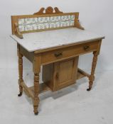 19th century pine washstand with tiled back, white marble tops, single drawer above a cupboard door,