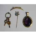 Gilt metal and pale amethyst coloured stone pendant, two ornate watch keys, a gold coloured metal