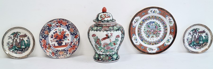 20th century Oriental lidded vase in black, green and red, two Oriental plates and two Oriental-