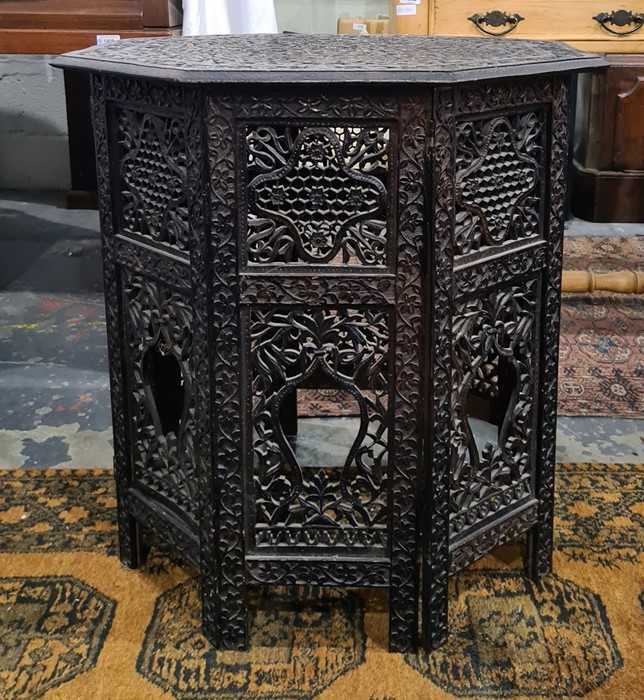 Anglo-Indian octagonal centre table with relief carved top with allover foliate decoration on