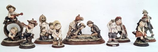 Nine Capodimonte figures by G Amani to include 'Gullivers World' and other figures of children at
