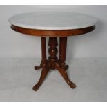 White marble topped centre table, the white marble with moulded edge on a central pillared turned