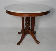 White marble topped centre table, the white marble with moulded edge on a central pillared turned