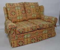 Modern two seater sofa in yellow, green and red upholstery