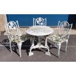 White painted circular aluminium garden table of Tudor rose design with three matching chairs,