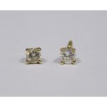 Pair of gold and diamond stud earrings (gold unmarked) (one earring broken), each earring approx 0.