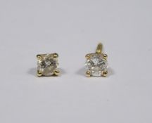 Pair of gold and diamond stud earrings (gold unmarked) (one earring broken), each earring approx 0.