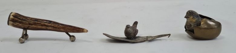 A cast bronze baby bird in cracked egg, 3cm high, another cast bronze bird on leaf and a horn
