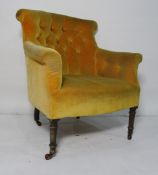Late Victorian armchair upholstered in mustard yellow, turned front legs to castors
