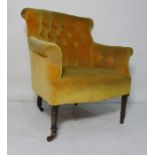 Late Victorian armchair upholstered in mustard yellow, turned front legs to castors