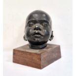 Painted plaster baby's head on wooden plinth base, unsigned, 17cm high in total