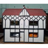 Tudor style cottage doll's house with some furniture
