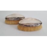 Pair of early 20th century gentleman's silver-mounted oval hairbrushes, of plain form (some small