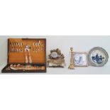 Cased set of flatware, a framed Delft tile, a Delft plate in pewter mount, an ormolu clock mount (