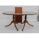 Mahogany and crossbanded D-end Regency style dining table with reeded edge raised on two pedestals