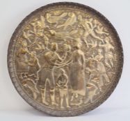 Eastern brass circular tray decorated with a western lady and gentleman shaking hands surrounded