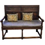 Handmade 19th century oak settle, panelled and carved back on turned supports, block feet and