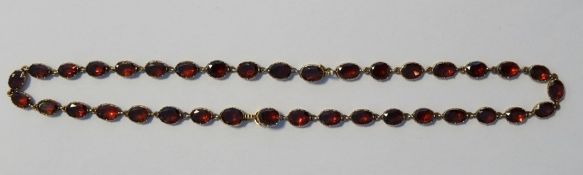 LOT WITHDRAWN 19th century ruby collarette necklace of thirty-seven oval facet cut stones, each