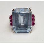Pale blue paste and ruby ring set centre rectangular step-cut paste stone (20mm x 14mm) flanked by