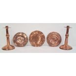 Pair of Arts & Crafts Birmingham School copper candlesticks and three assorted circular copper