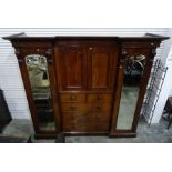 Victorian mahogany breakfront wardrobe compactum, the moulded cornice above two central arched