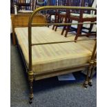 Pair of tubular brass framed beds by Maples, raised on castors, bearing ivorine plaques