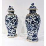 A pair of Chinese lidded baluster vases, full character mark for Kangxi (both damaged)(23cm)