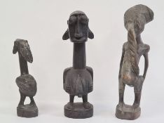 African carved fertility figure, 24cm high, another carved small fertility figure, 17.5cm and a