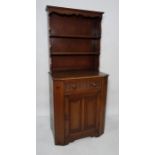 20th century dresser, the top with open shelves above base of single drawer and cupboard and door,