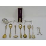 Assorted foreign silver white metal wares to include strainer, teaspoons, knife rests, etc
