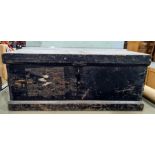 Early 20th century black painted pine trunk with iron hasp and some shipping labels