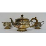 1940's silver teapot, matching milk jug and two-handled sugar bowl with wooden finial and handle,