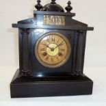 A 20th Century ebonised wooden mantel clock, with frieze decorated with figures, Roman numeral dial,
