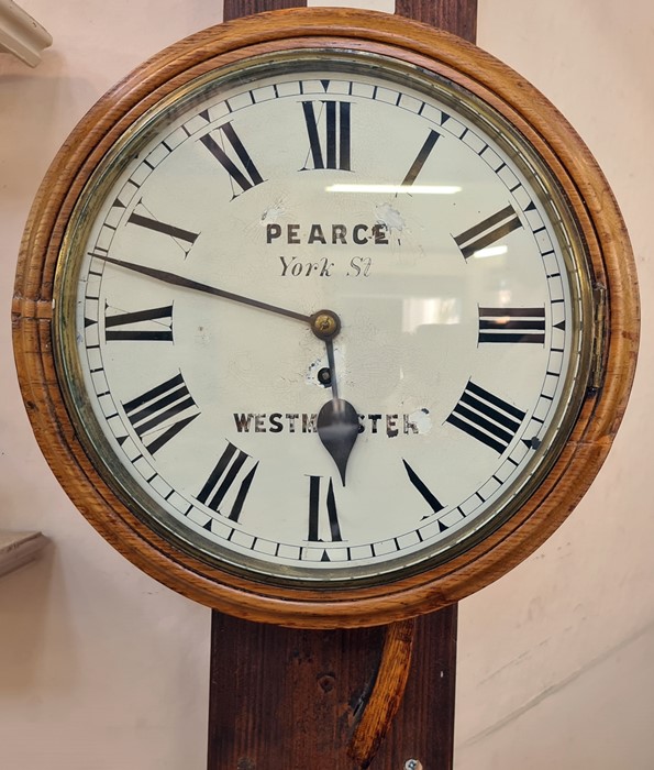 A 20th Century oak circular wall clock, Pearce York St, Westminster, Roman numeral enamel dial, 38cm