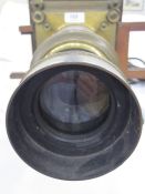 A Victorian magic lantern, black cold painted lid, wooden with adjustable viewing lens on plinth