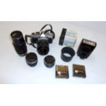 Olympus OM-1 camera with four lenses, an electronic flash, filters, auto-zoom and instruction manual