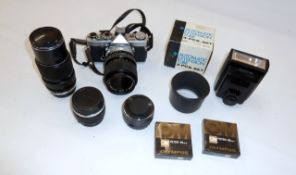 Olympus OM-1 camera with four lenses, an electronic flash, filters, auto-zoom and instruction manual