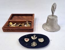 A small quantity of military badges and buttons in wooden box and a RAF Benevolent Fund bell