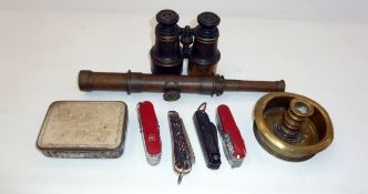 A pair of binoculars, assorted penknives, extending telescope, brass candlestick and a tin (one