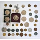 An undated 20p coin and a small quantity of English and foreign coins in tin