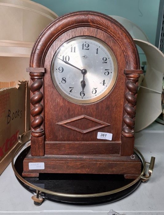 1950's oak-cased mantel clock with barley twist columns and Arabic numerals and a black and brass