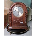 1950's oak-cased mantel clock with barley twist columns and Arabic numerals and a black and brass