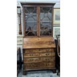 Early 19th century mahogany bureau bookcase, the dentil cornice above pair astragal-glazed folding