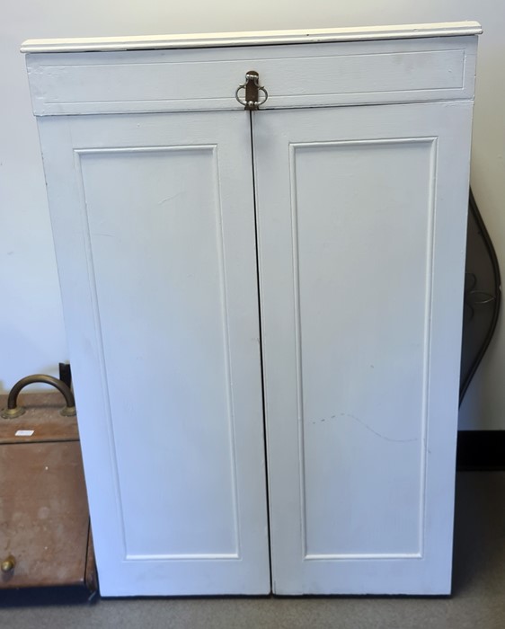 White painted two-door wardrobe, the hinged mechanism doors opening to reveal integral hanging