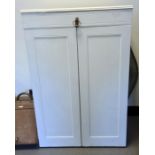White painted two-door wardrobe, the hinged mechanism doors opening to reveal integral hanging