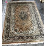 A Persian style rug central medallion foliate decoration borders  in dark brown and green;