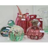 Four paperweights, a pair of cranberry small decanters, a Murano cranberry and gold jug with pointed