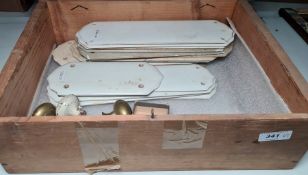 Vintage box containing white ceramic door plates, brass door handles, etc